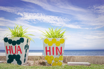 HUA HIN letter written on a plant pot, Landscape of beach and sea in Pranburi nearby Hua Hin, Thailand.