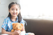 © Recycle Man - Patient girl smiling with her bear at Hospital's Bed