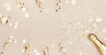 Champagne Bottle With Confetti Stars, Bokeh Decoration And Party Streamers On Golden Background. Christmas, Birthday Or Wedding Concept. Flat Lay.