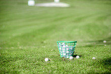 Basket Full Of Golf Balls On The Playing Course Outdoors