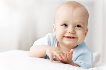 Smiling baby on the bed