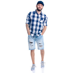 Man in jeans shorts, cap, casual clothing standing smiling on white background isolation