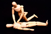 Conceptual Image Of Wooden Manikins Administering CPR Resuscitation