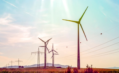 Wind turbines with power line in the sunset 