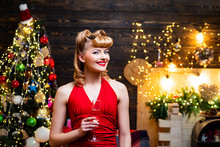 Very Beautiful Blonde Girl Over Christmas Tree. Retro Pin-up Woman Posing On Vintage Wooden Christmas Background.