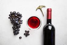 Red Wine In A Glass And Ripe Grapes On White Background, Top View