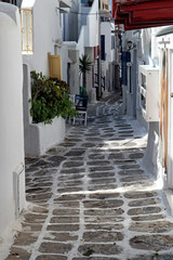 Wall Mural - White painted paved back street in Mykonos old town, Greek Islands