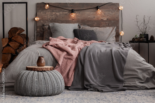 Fotografía Yerba matte on wooden plate on grey woolen pouf in stylish bedroom interior