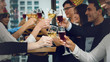 © Mongkolchon - group of business people enjoying party and clinking glass of champagne and wine together to celebrate corporate success and new year event
