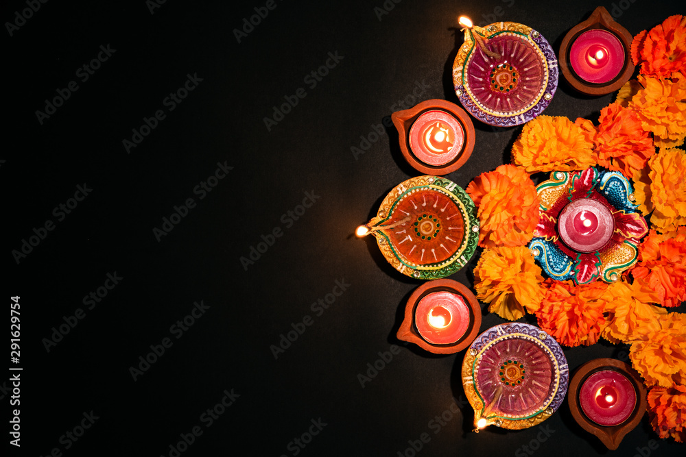Happy Diwali - Clay Diya lamps lit during Dipavali, Hindu festival of lights celebration. Colorful traditional oil lamp diya on white background - obrazy, fototapety, plakaty 