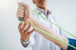 © joyfotoliakid - Physiotherapist man giving resistance band exercise treatment About Chest muscles and Shoulder of athlete male patient Physical therapy concept