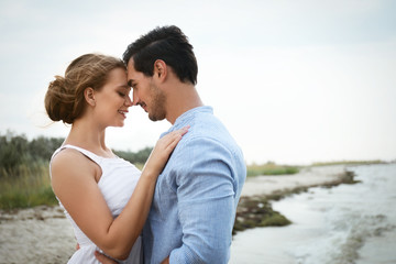 Poster - Happy young couple spending time at sea beach