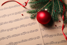 Flat Lay Composition With Christmas Decorations On Music Sheets, Space For Text