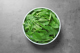 Fototapeta Tematy - Fresh green healthy spinach on grey table, top view