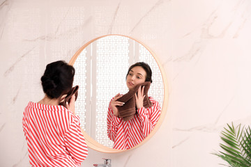 Sticker - Young woman with towel near mirror in bathroom