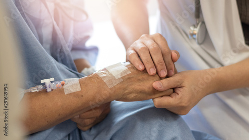 Fotografía Elderly female hand holding hand of young caregiver at nursing home