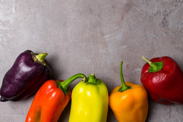 Wall Mural - colorful bell peppers, concrete background, copy space