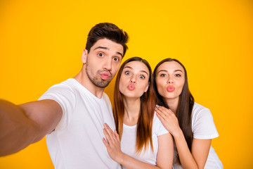 Poster - Self-portrait of three nice attractive lovely lovable charming cheerful cheery positive person sending you kiss having fun isolated over bright vivid shine yellow background