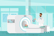© idambeer - doctor standing and man lying down for x-ray with MRI scanner machine