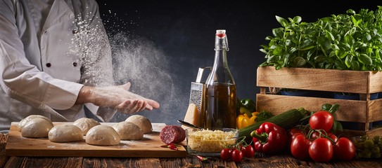 Wall Mural - Chef clapping his floured hands creating a cloud