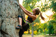 © Maksym Protsenko - Beautiful Woman Climbing on the Rock in the Mountains. Adventure and Extreme Sport Concept