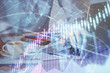 © peshkova - Forex graph with businessman working on computer in office on background. Concept of hardworking. Multi exposure.