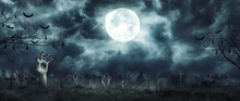 Zombie Rising And Hands Out Of A Graveyard Cemetery Scary In Spooky Dark Night Full Moon. Holiday Event Halloween Concept.