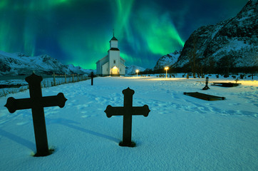 Wall Mural - northern lights over winter landscape with church and graveyard