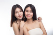 © Johnstocker - Two young women happily stood together from behind.