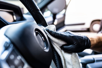 Cleaning the car steering wheel. Car detailing.