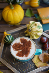 Poster - Cup of coffee with cinnamon on an open table