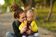 © natalialeb - mom and daughter together eat ice cream in park