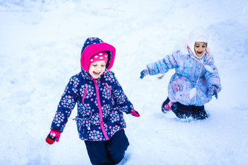 Wall Mural - Two beautiful happy sisters winter outdoors.