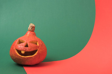 Canvas Print - spooky Halloween pumpkin on red and green background