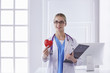 © lenetsnikolai - Doctor with stethoscope holding heart, isolated on white backgr