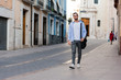 © Cristian Blázquez - Young businessman is walking on the street with his backpack