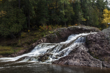 autumn colors line the gorge at the great conglomerate falls overlook in the ottawa national forest.