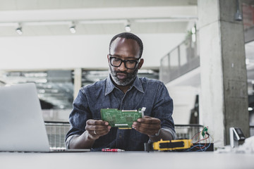African American adult male working on robotics