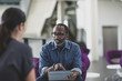 © ReeldealHD images - African American businessman using a digital tablet in a meeting