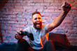 Emotional guy playing video game at home. Concept of gaming and technology. Relax