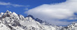 Snow winter mountains and blue sky with clouds at sun day