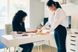 © Gerald Carter/Creative Flame - Direct view of two young businesswomen in modern office space