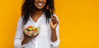 Smiling african american girl eating healthy salad