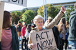 © Halfpoint - Senior with placard and poster on global strike for climate change.