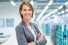 Portrait Of A Smiling Businesswoman In A Modern Factory