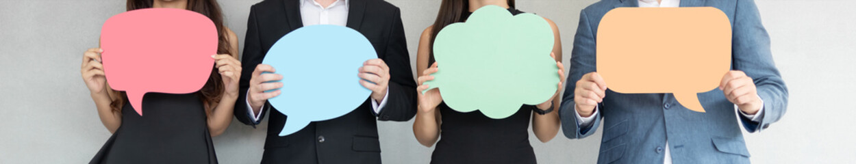 people are holding colorful speech bubbles.