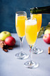 Apple mimosa cocktail in tall flute glasses, fall drinks