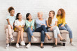 © Prostock-studio - Multiethnic Women Looking At Each Other Sitting On Sofa Indoor