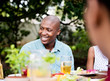 © Greatstock - Man laughing at the lunch table