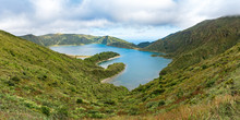 Panoramic View Of Lagoa Do Fogo, A Crater Lake On The Island Of São Miguel In The Azores Archipelago.  The Blue Lagoon Is In The Central Caldera Of The Água De Pau Massif, Pictured Under A Cloudy Sky.